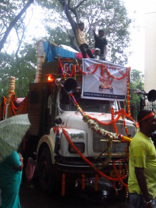 A decorated truck with two children standing on top it