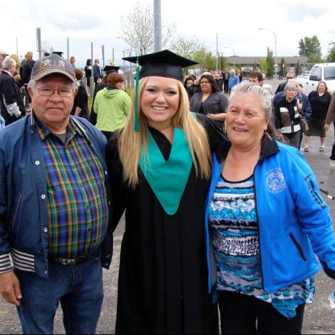 Kayla during grad with two family members