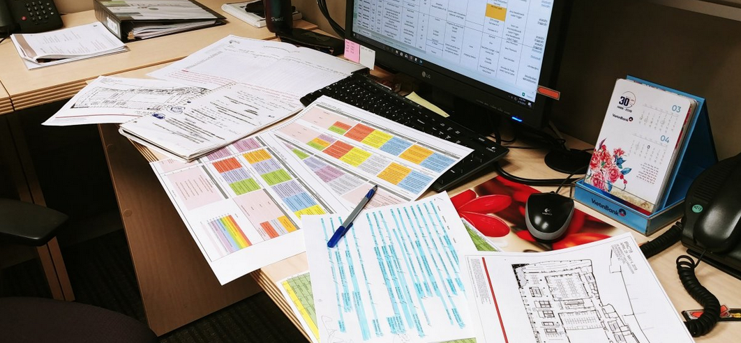 A bundle of notes and schedules and papers spread throughout the table.
