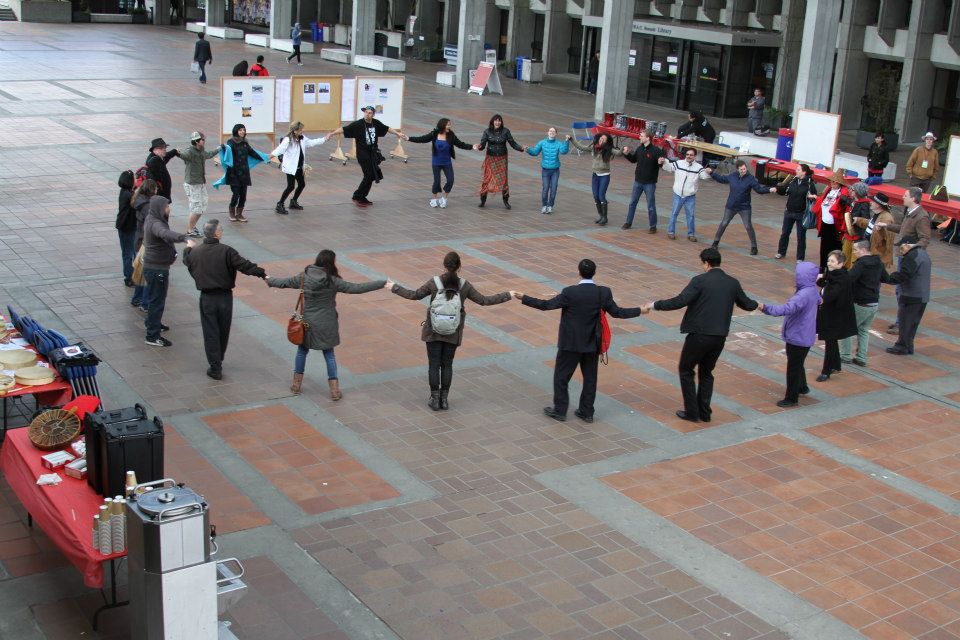 SFU students standing in a circle holding hands