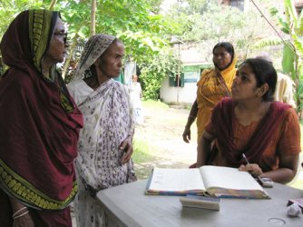 image of women surrounding a book