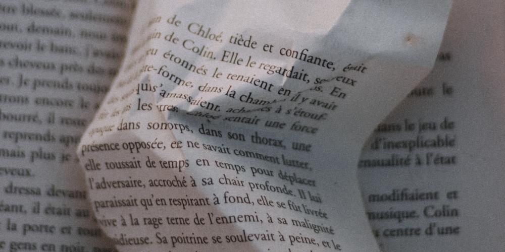 A french book with a page crumpled up 