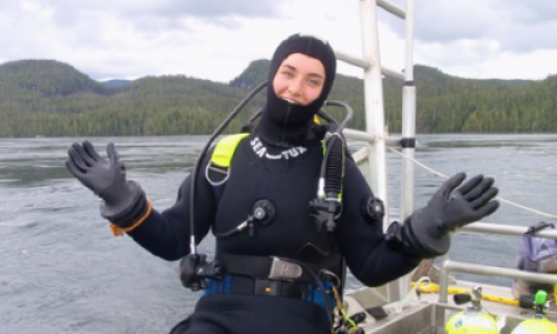Jill in scuba diving gear on a boat 