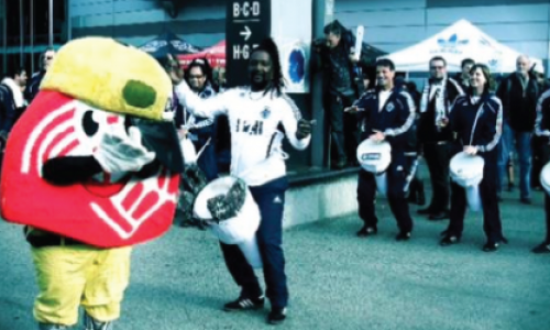 Picture of a mascot with people in the background