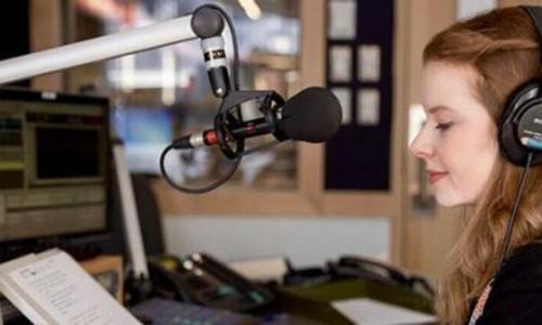 girl with headphones on in radio station