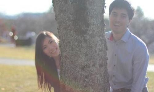 Jason Yeh and his friend posing behind a tree