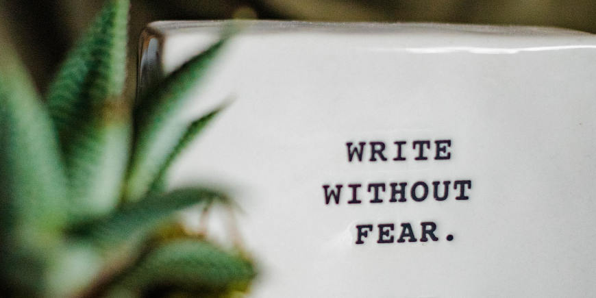 A ceramic block with the words "Write Without Fear" printed ontop