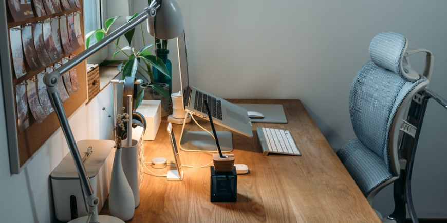 White working desk filled with work place paraphernalia 