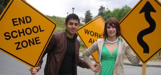Students holding road signs