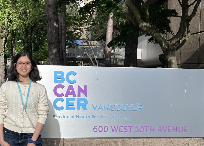 Rizzek standing beside BC Cancer Sign
