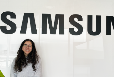 A photo of a person in the Samsung Electronics Vancouver office, with the Samsung logo above the individual