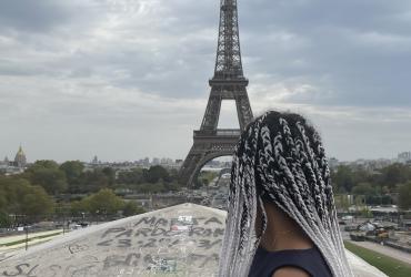 Person facing away from the camera facing the Eiffel tower 