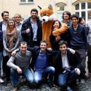 Chesa and coworkers surrounding a mascot fox