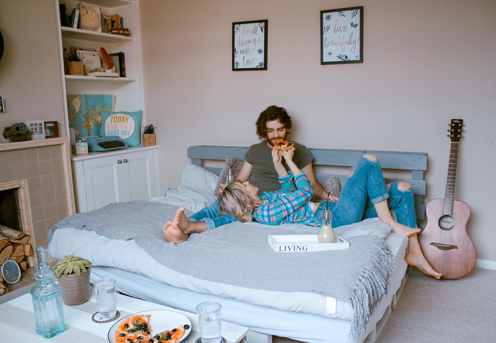 A photo of a man and a woman lounging at home