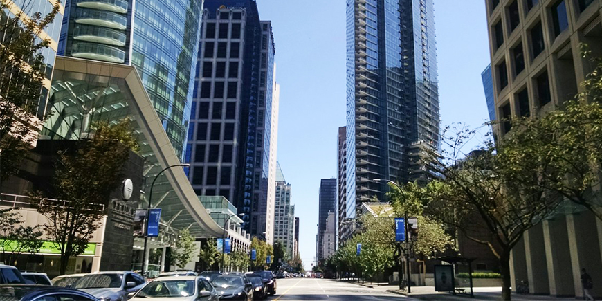 a street view of highrises in downtown Vancouver