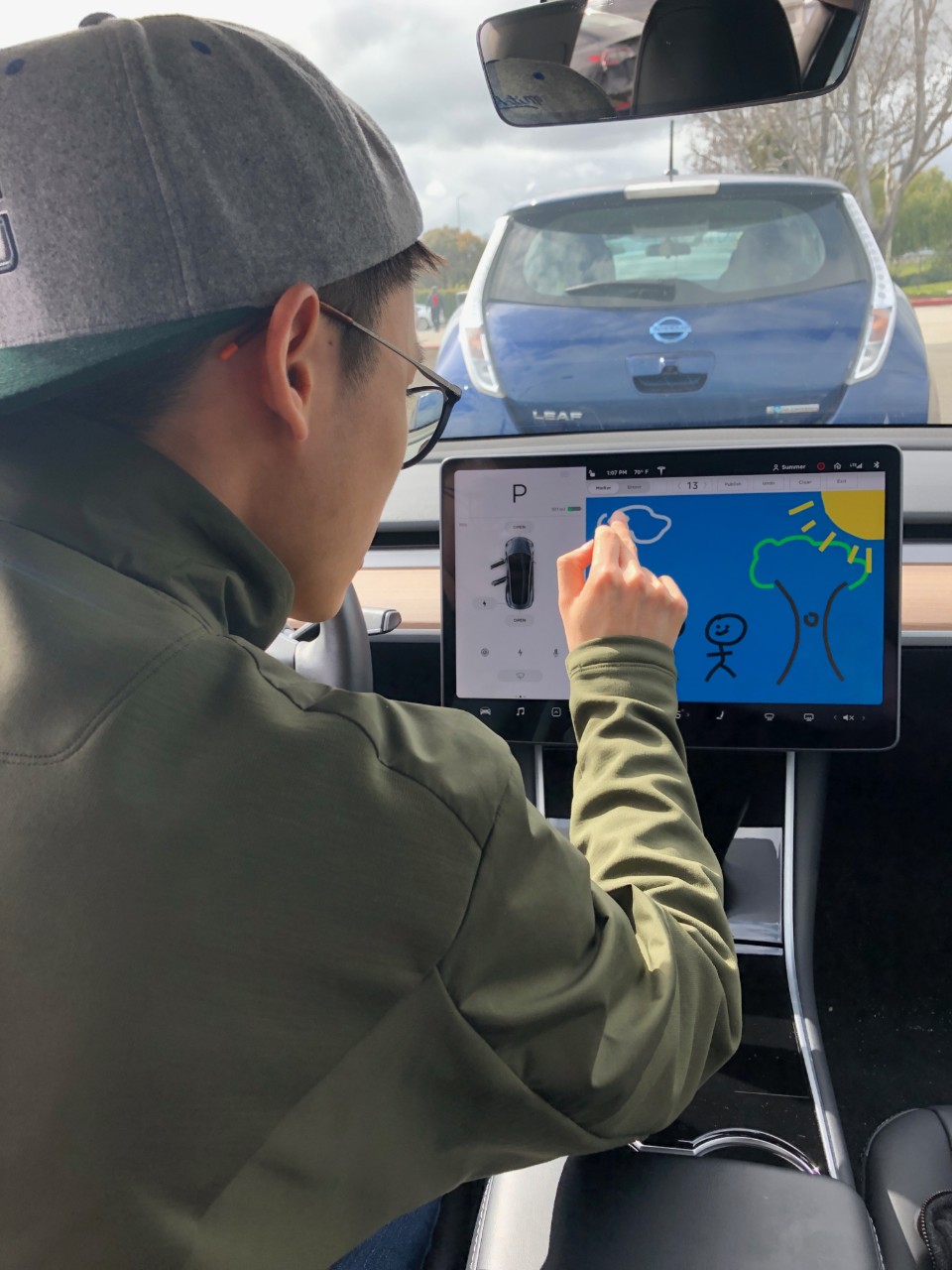 Wong working on a digital painting on a Tesla's monitor