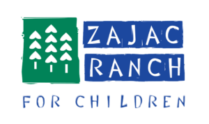 White trees on a green background to the left. "ZAJAC RANCH" written in white on a blue background to the right. "FOR CHILDREN" written along the bottom of the image.