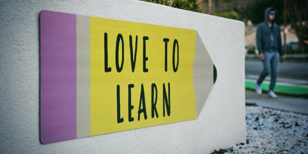 a wall with the text "Love to Learn"