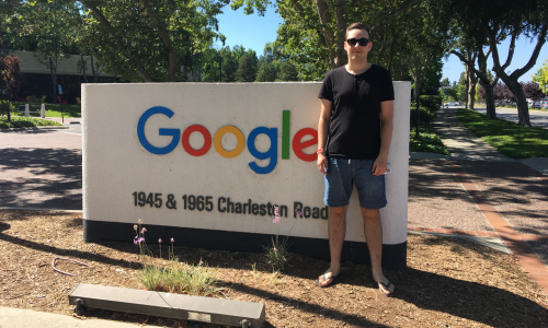 Paull standing beside the Google headquarters sign