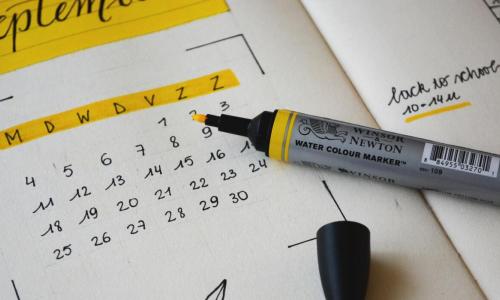 A calendar showing the month of September beside yellow highlighter 