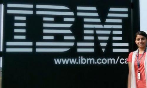 Harpreet in front of IBM logo