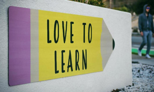 a wall with the text "Love to Learn"