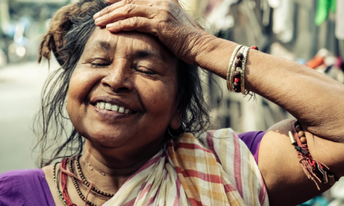 smiling woman from Kolkata, hand on her forehead