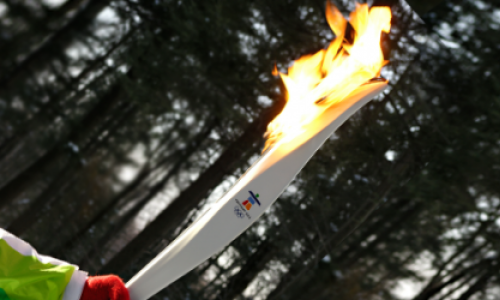 A person holding a Olympic torch 