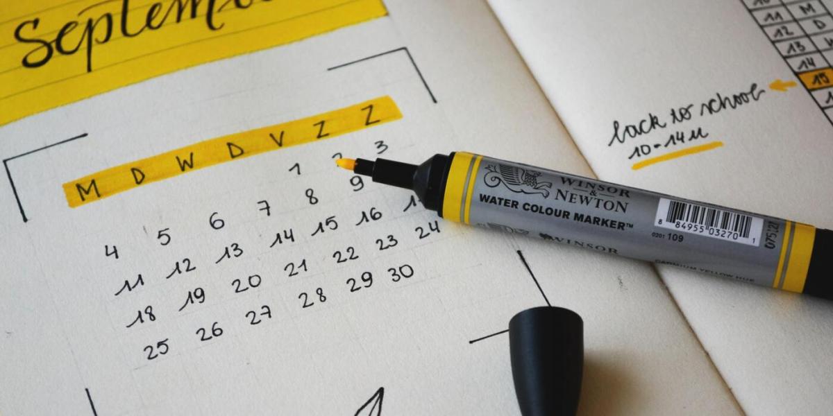 A calendar showing the month of September beside yellow highlighter 