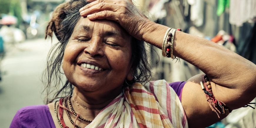 smiling woman from Kolkata, hand on her forehead