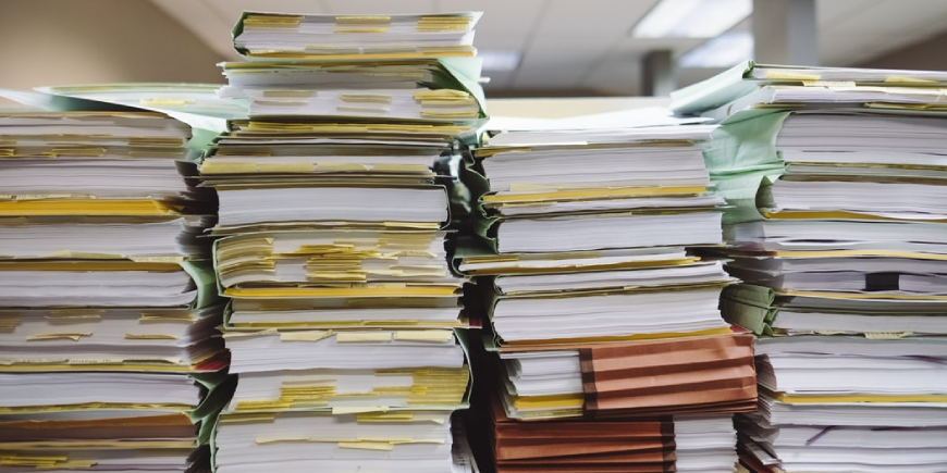 Stacked paperwork showcasing a high caseload
