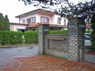 Picture of a building with a fence known as Cherington Place, a nursing home located in Surrey, British Columbia.
