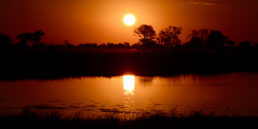 Okavango delta, botswana; sunset over water