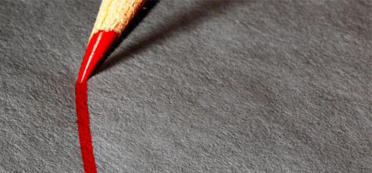 Red pencil crayon drawing a line