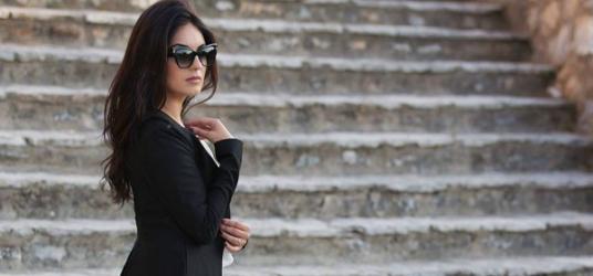 Women wearing a black dress and sunglasses