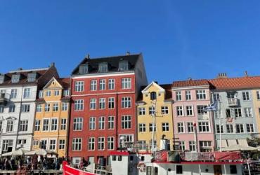 Colourful houses near canal with boats and Nyhavn street in Denmark