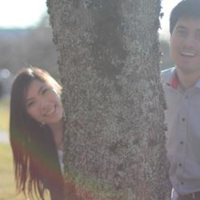 Jason Yeh and his friend posing behind a tree