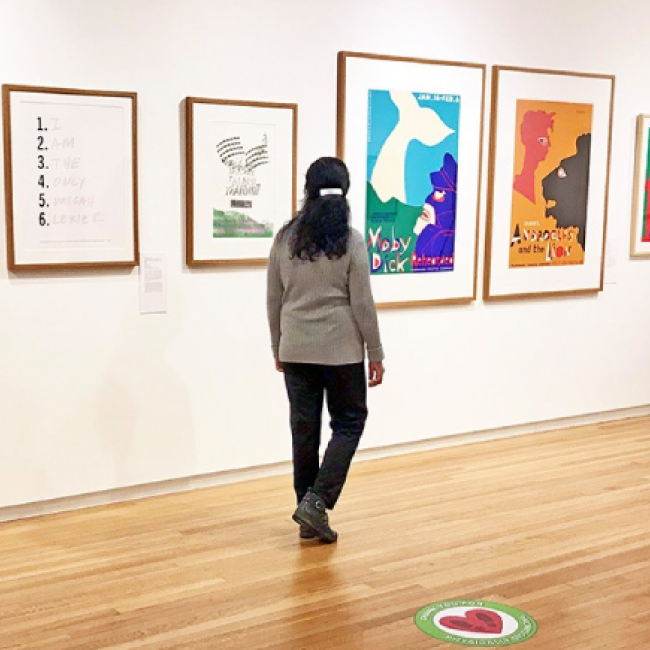 A person walking through an art gallery