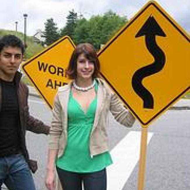 Woman in front a road sign