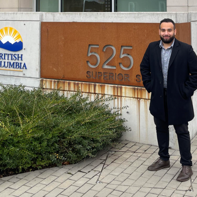 George standing outside, next to a British Columbia sign