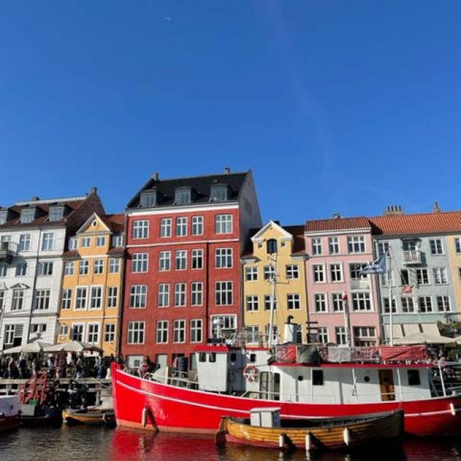 Colourful houses near canal with boats and Nyhavn street in Denmark