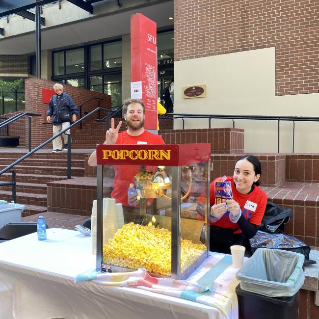 Kiara working at the popcorn machine during the 2023 Welcome Back BBQ