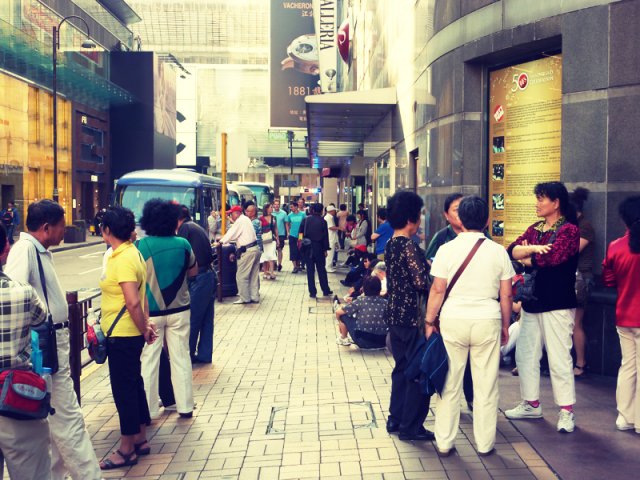 an image of the sidewalk and the people on the streets in hong kong
