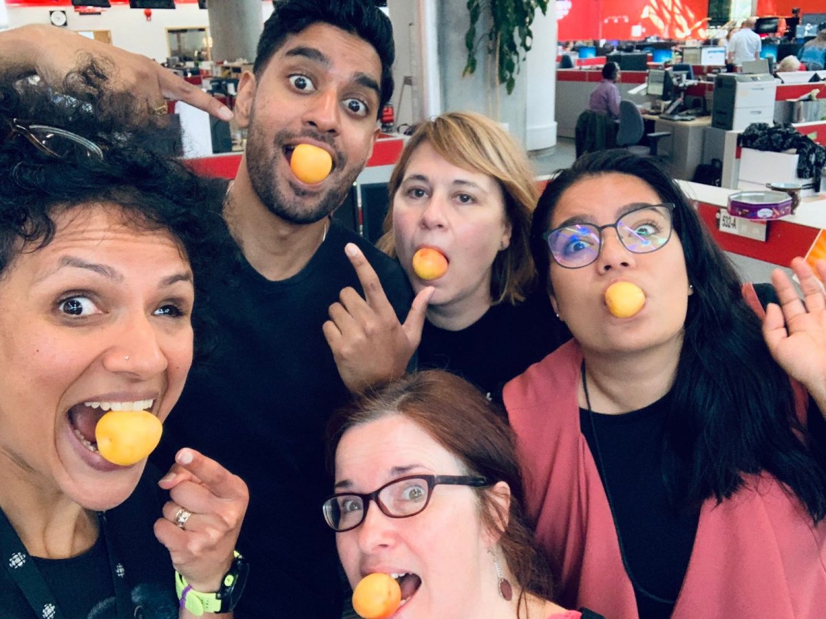 Sonya and her friends goofing around, stuffing their faces with yellow ball-shaped food on a stick