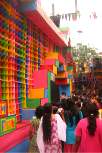 People lining up to enter a colourful building