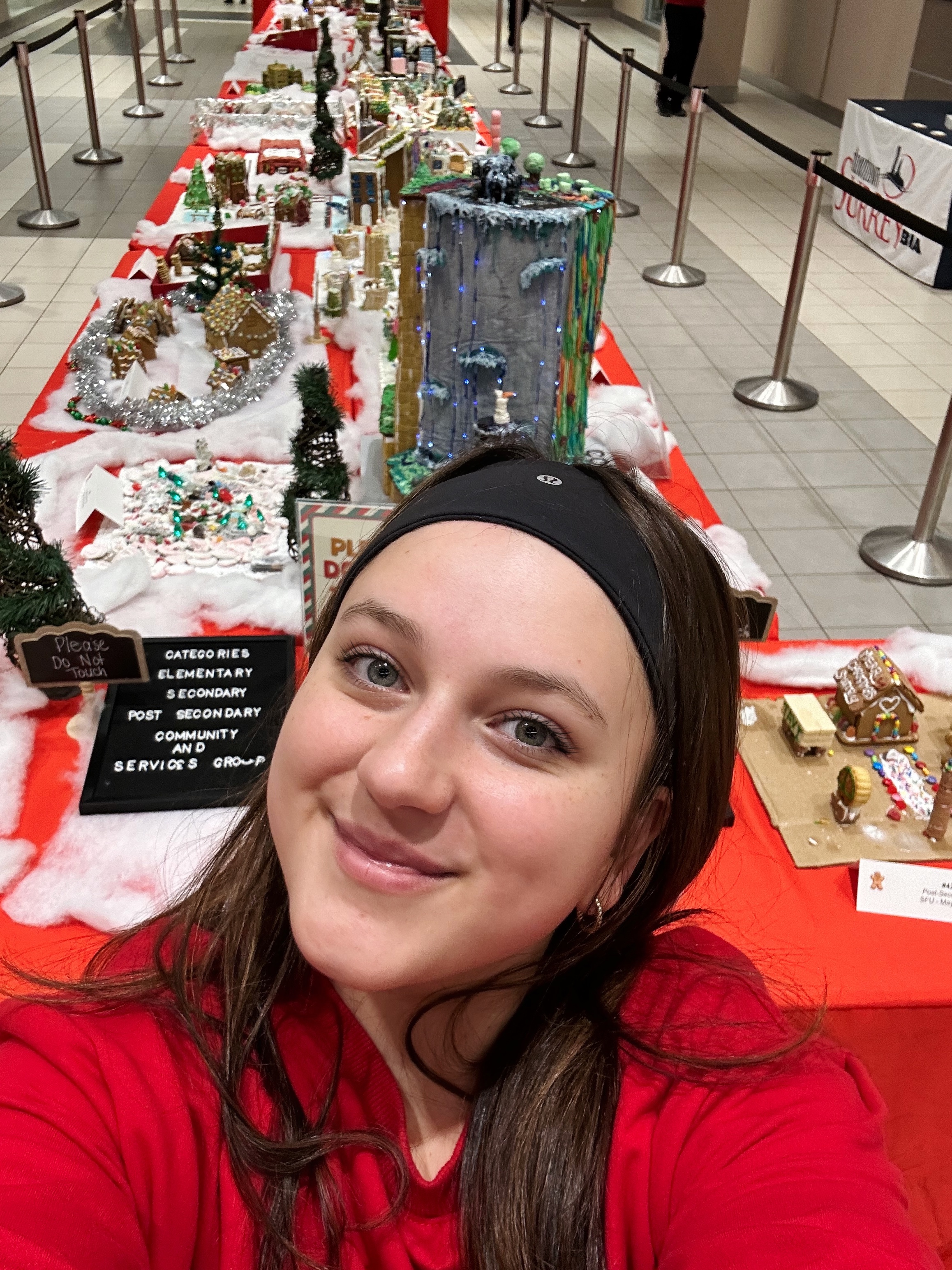 Girl posing with gingerbread village 