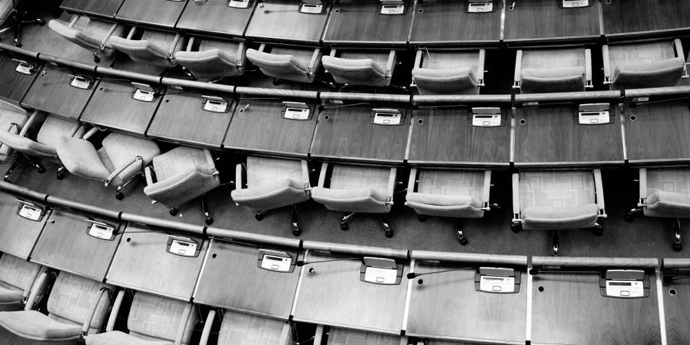 Rows of chairs; a political chamber