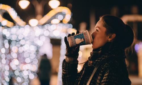 a girl drinking coffee during Christmas time