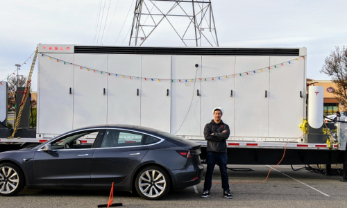 Rick standing in front of a Tesla car