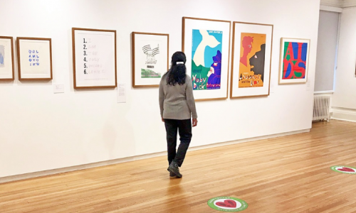 A person walking through an art gallery
